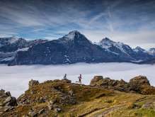 Trail running in Grindelwald above a sea of fog. In the background, the Eiger rises out of the fog.