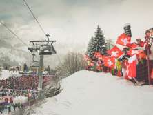 A snapshot from the Lauberhorn Race in Wengen. Swiss fans cheer on the skiers from the side of the course.